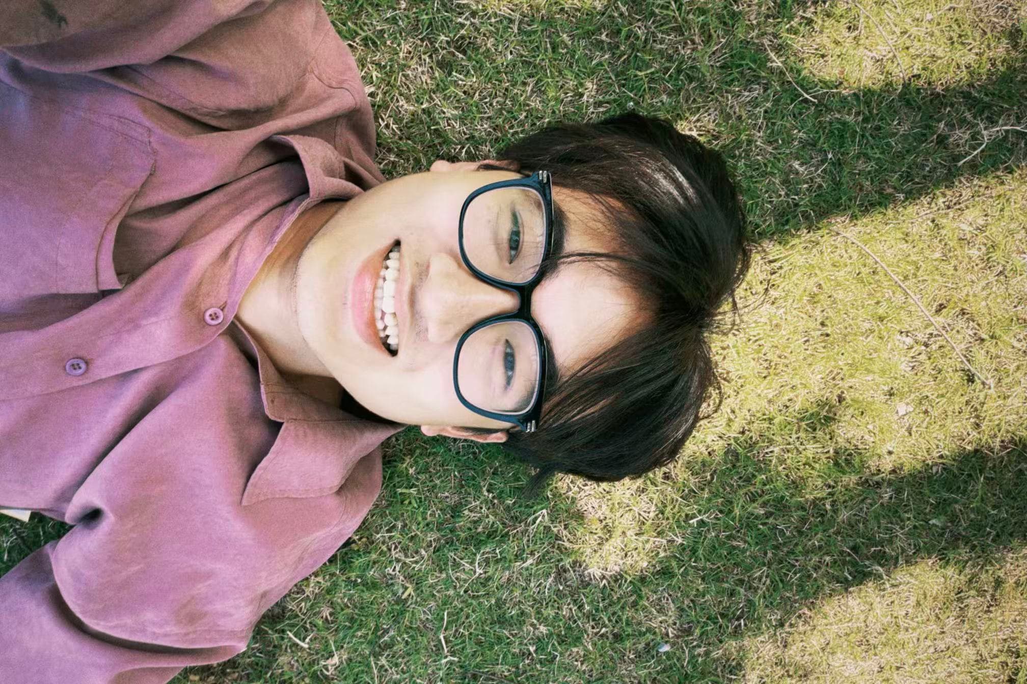 Bubu lying on the grass, smiling